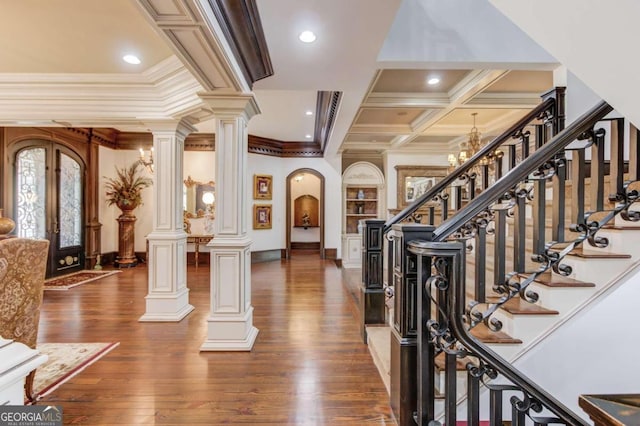 foyer with french doors, crown molding, dark hardwood / wood-style flooring, coffered ceiling, and a notable chandelier