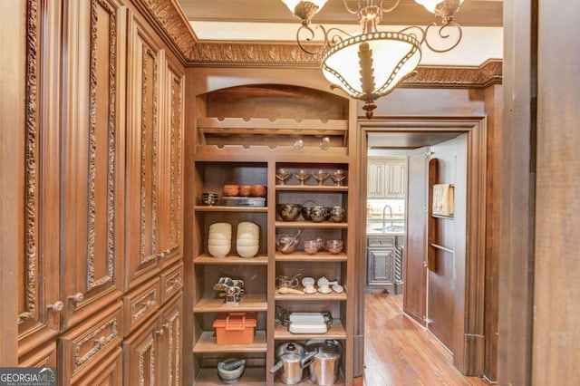 wine cellar featuring sink and light hardwood / wood-style flooring