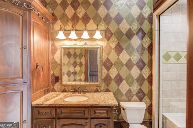 bathroom featuring tile walls, oversized vanity, toilet, and walk in shower