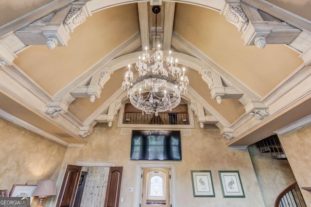 room details with beam ceiling, ornamental molding, and an inviting chandelier