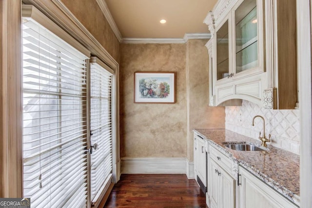 kitchen featuring light stone countertops, ornamental molding, dark wood-type flooring, and white cabinetry