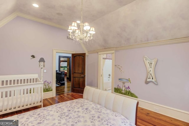 bedroom with an inviting chandelier, lofted ceiling, dark wood-type flooring, and a crib