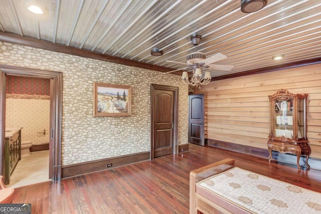 bedroom with ensuite bath, dark hardwood / wood-style flooring, and ceiling fan