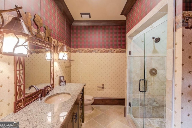 bathroom with tile floors, a shower with shower door, vanity with extensive cabinet space, and toilet