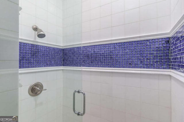 interior details featuring a shower with door