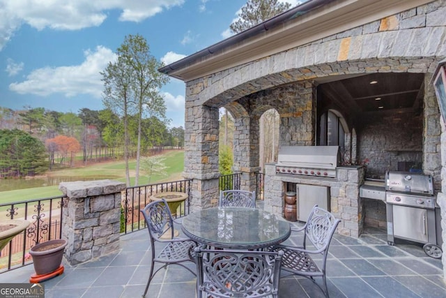 view of terrace with an outdoor kitchen and grilling area