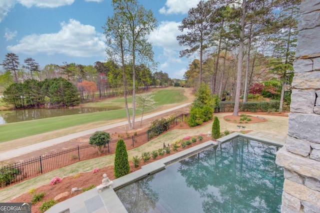 view of swimming pool featuring a lawn