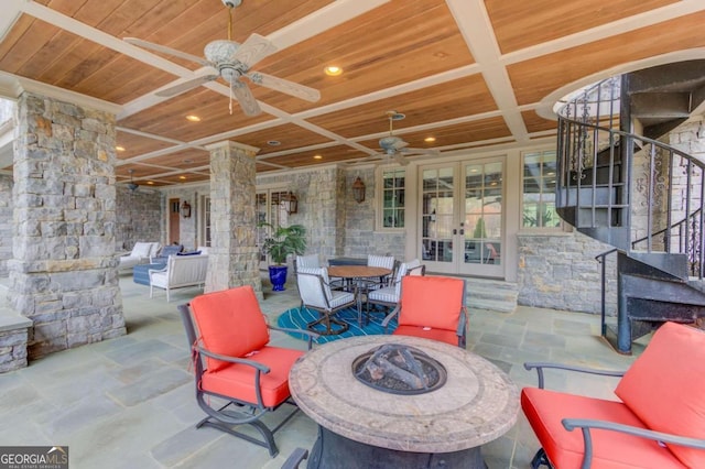 view of patio featuring ceiling fan, an outdoor living space, and french doors