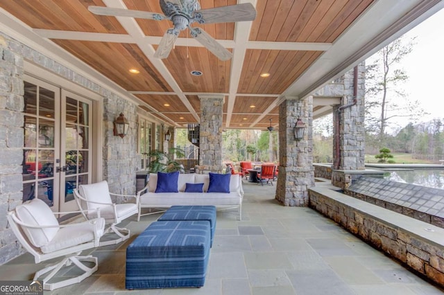 exterior space with ceiling fan and an outdoor living space