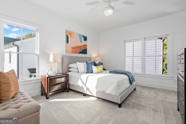 bedroom featuring light carpet and ceiling fan