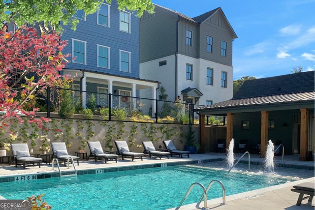 view of pool with a patio area and pool water feature