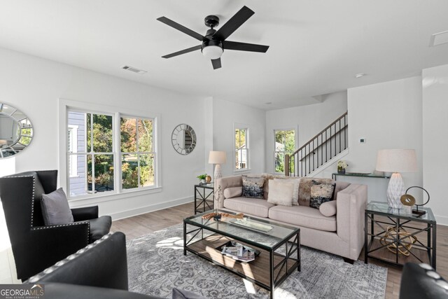 living room with a healthy amount of sunlight, ceiling fan, and hardwood / wood-style floors