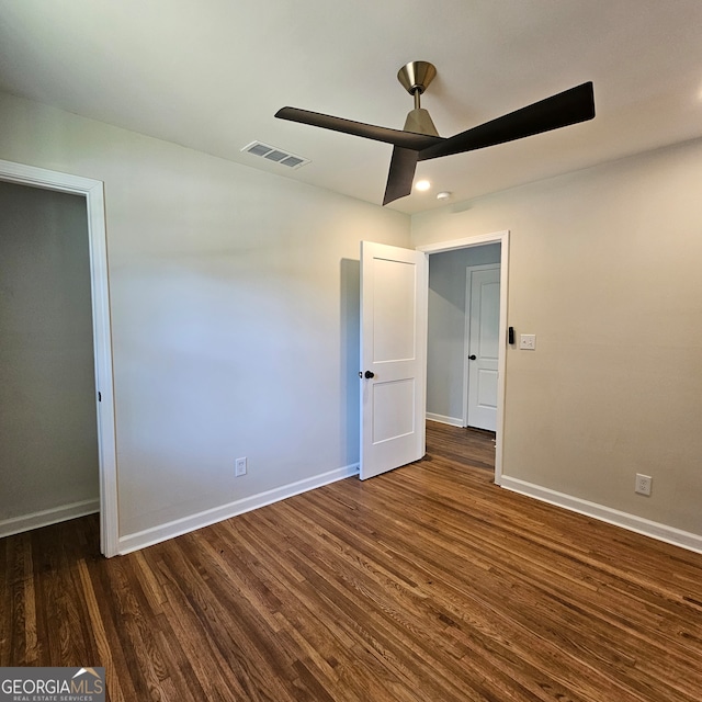 unfurnished bedroom featuring ceiling fan, dark wood-type flooring, and a closet