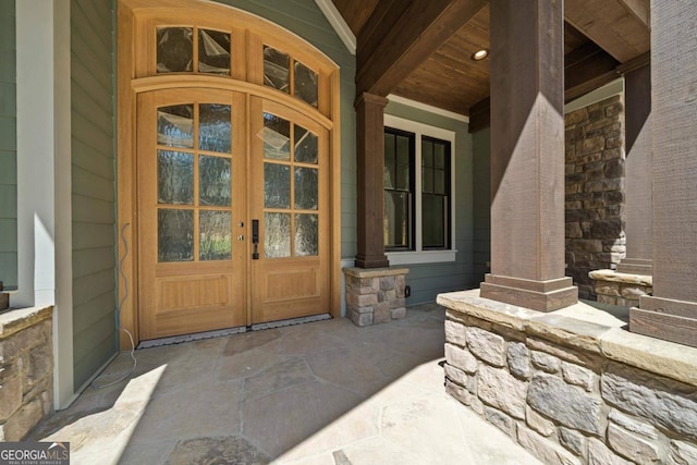 entrance to property with french doors and a porch