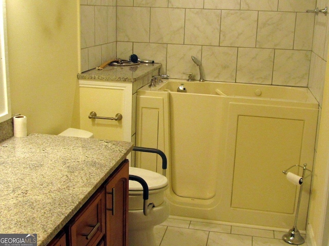 bathroom featuring toilet, vanity, tasteful backsplash, a bath, and tile floors