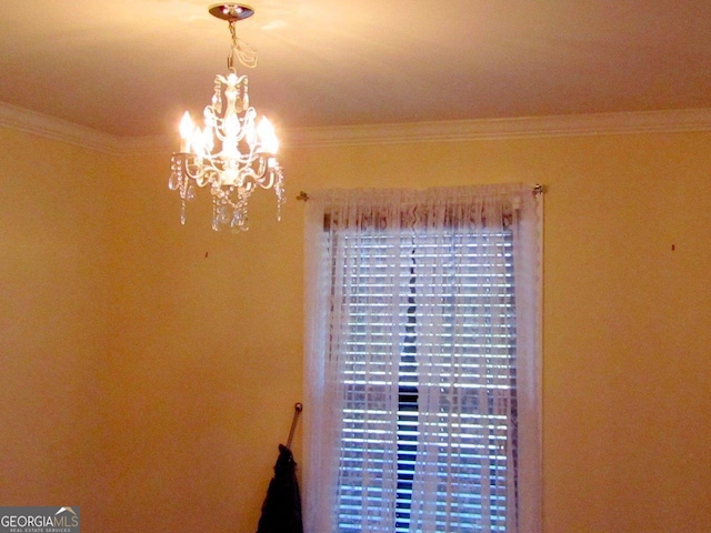 interior details with an inviting chandelier and ornamental molding