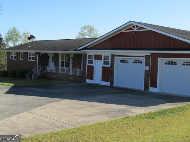 ranch-style house featuring a porch and a garage