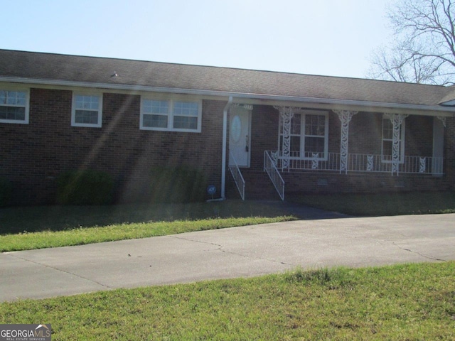 single story home with covered porch and a front lawn