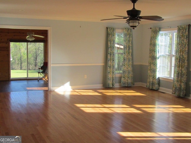 unfurnished room featuring ceiling fan, ornamental molding, and dark hardwood / wood-style flooring