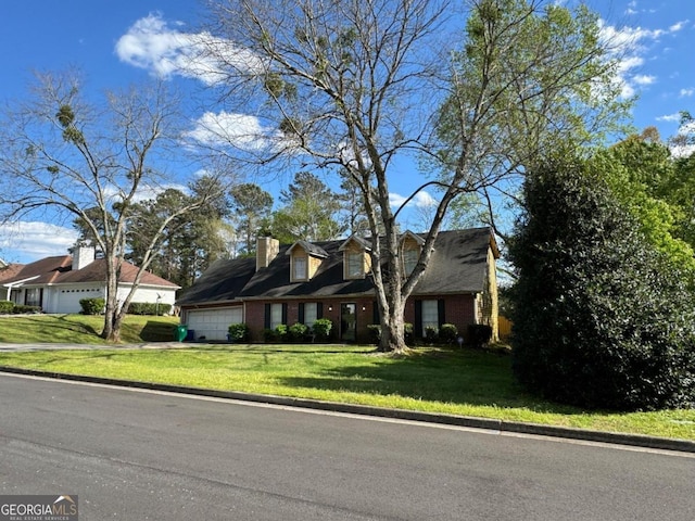 cape cod house with a garage and a front lawn