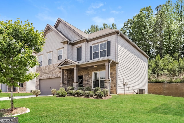 craftsman house featuring a garage, central AC unit, and a front yard