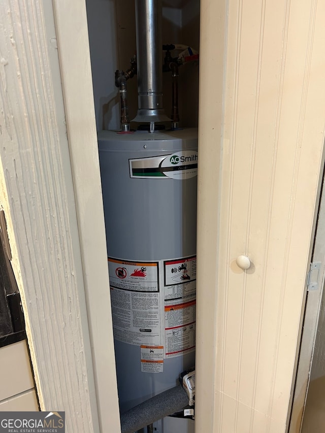 utility room with gas water heater