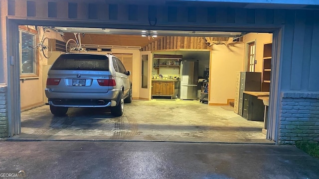 garage with stainless steel fridge