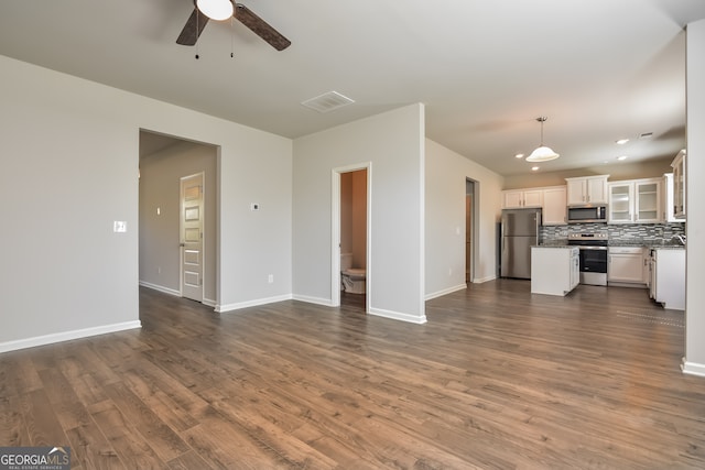 unfurnished living room featuring ceiling fan and hardwood / wood-style flooring