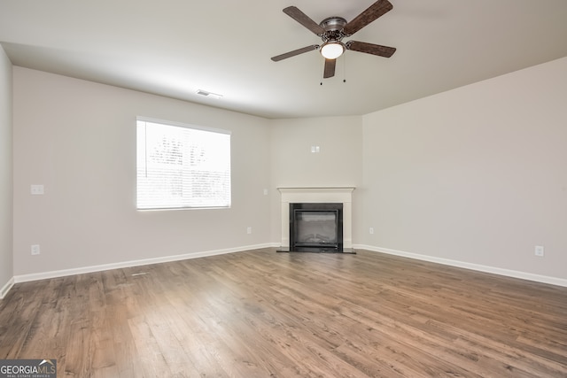 unfurnished living room with light hardwood / wood-style flooring and ceiling fan