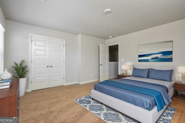 bedroom with a closet and light parquet flooring