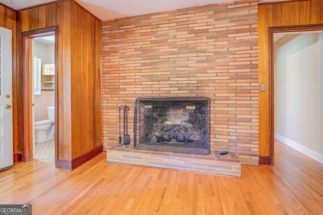 unfurnished living room featuring ornamental molding, light hardwood / wood-style flooring, and a fireplace