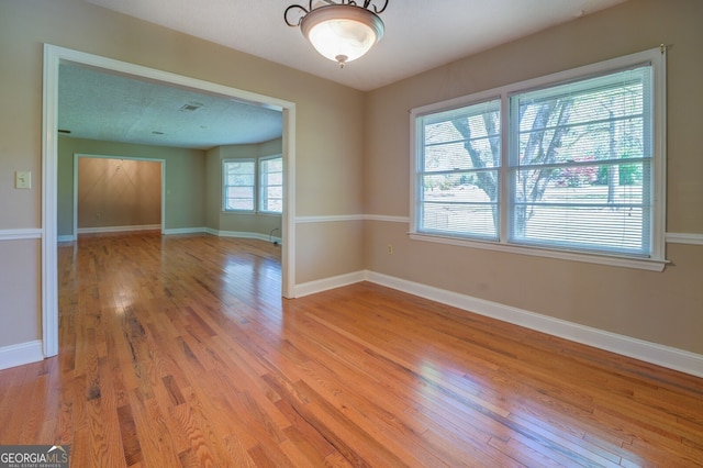 spare room featuring light hardwood / wood-style floors