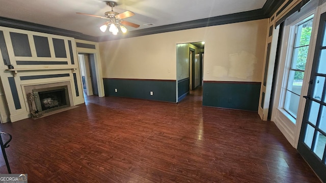 unfurnished living room featuring ornamental molding, ceiling fan, and dark hardwood / wood-style floors