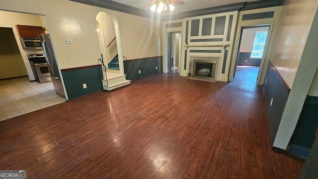 unfurnished living room with tile floors and ceiling fan