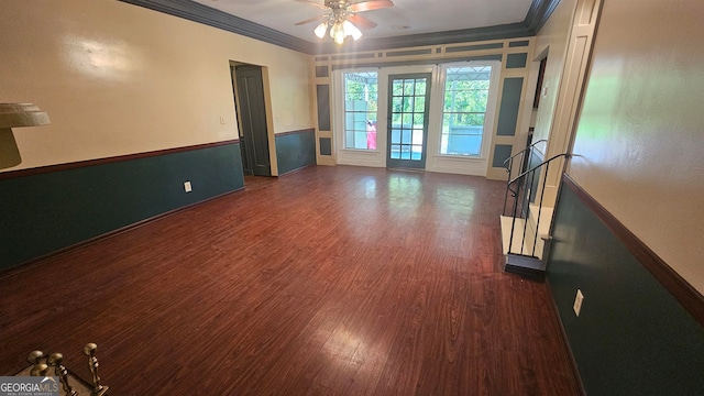 unfurnished room with ornamental molding, ceiling fan, and dark wood-type flooring