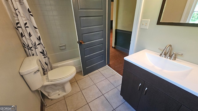 full bathroom featuring vanity with extensive cabinet space, toilet, tile floors, and shower / bath combination with curtain