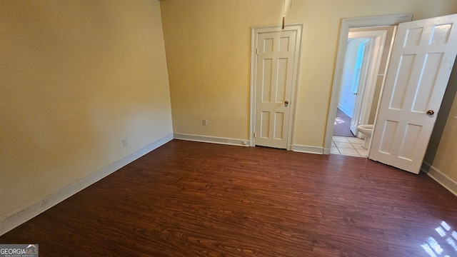 unfurnished bedroom featuring dark hardwood / wood-style flooring