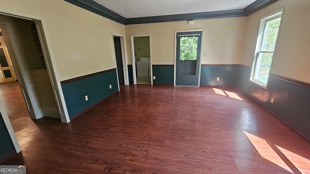 unfurnished room featuring a healthy amount of sunlight, dark hardwood / wood-style flooring, washer / dryer, and ornamental molding