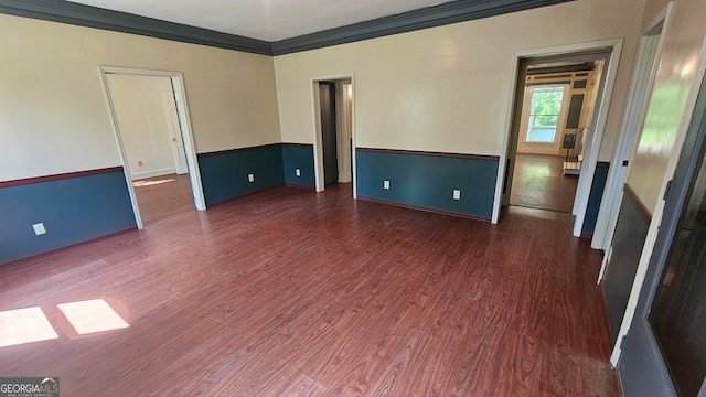 unfurnished room featuring dark hardwood / wood-style flooring and ornamental molding