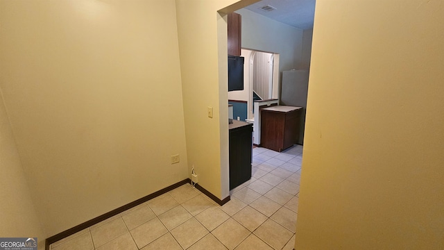 corridor featuring light tile flooring