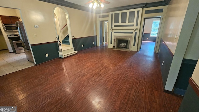 unfurnished living room featuring tile flooring and ceiling fan