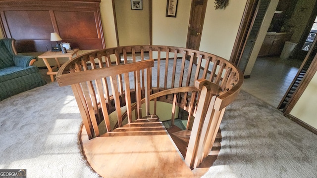 stairs featuring light colored carpet