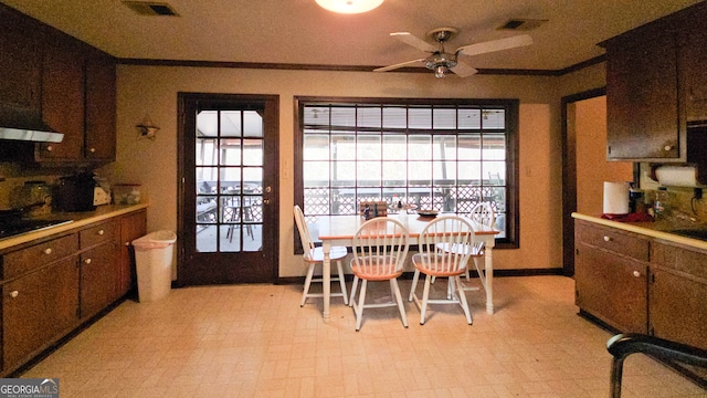 dining area featuring ceiling fan and ornamental molding