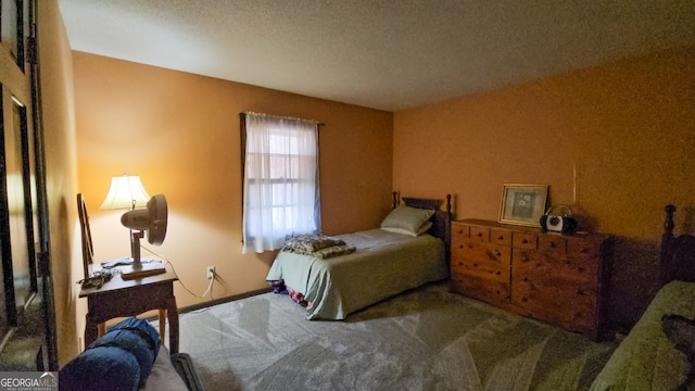 bedroom featuring a textured ceiling and carpet floors