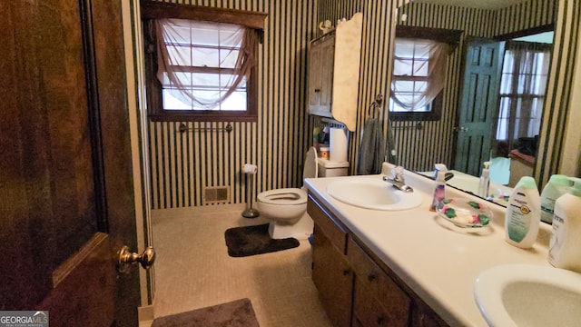 bathroom featuring toilet and vanity