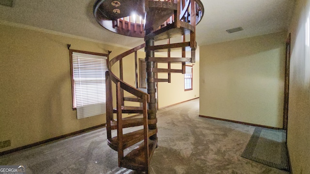 staircase featuring carpet floors and ornamental molding