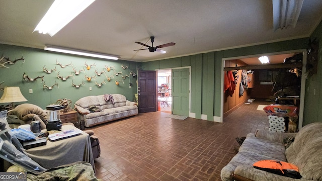 living room with ceiling fan and ornamental molding