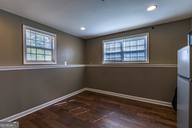 spare room with dark hardwood / wood-style floors