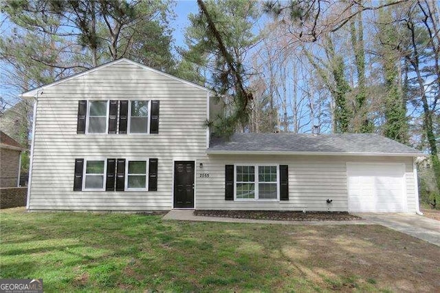 view of front facade with a garage and a front lawn