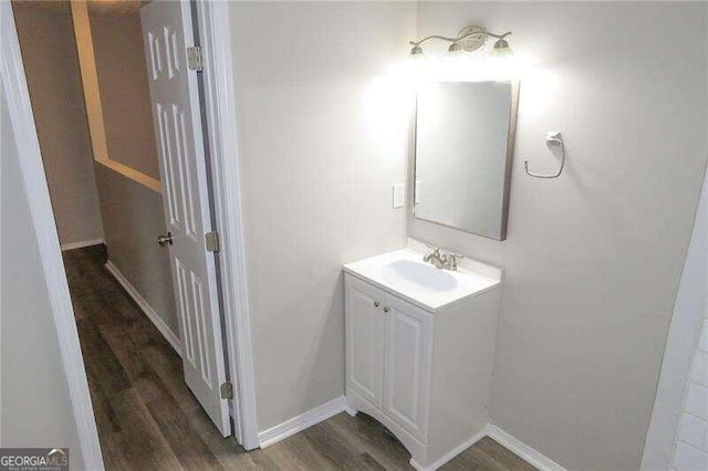 bathroom featuring hardwood / wood-style flooring and vanity